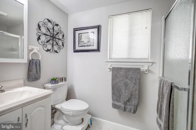 a white toilet sitting next to a bathroom sink