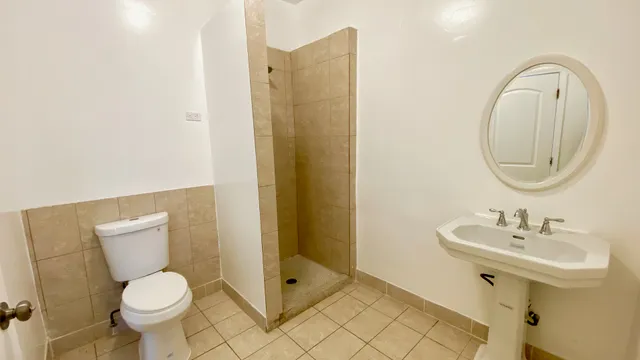 a bathroom with a toilet sink and a mirror