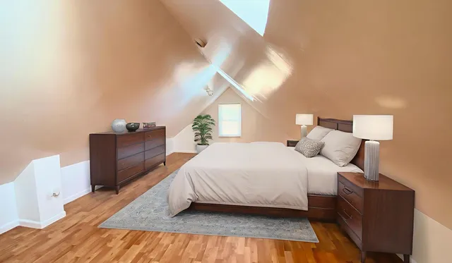 a spacious bedroom with a bed and a cabinets