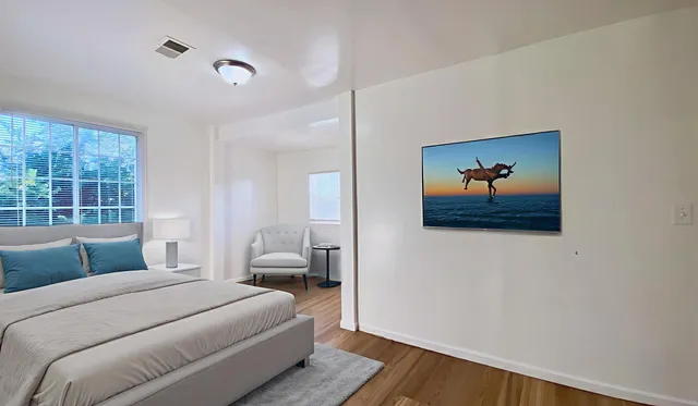 a bedroom with a bed and a window