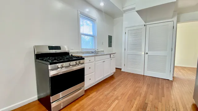 a kitchen with wooden floors and white appliances