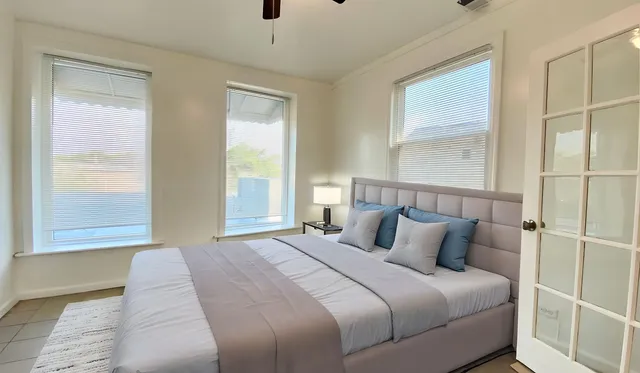 a bedroom with a large bed and a large window