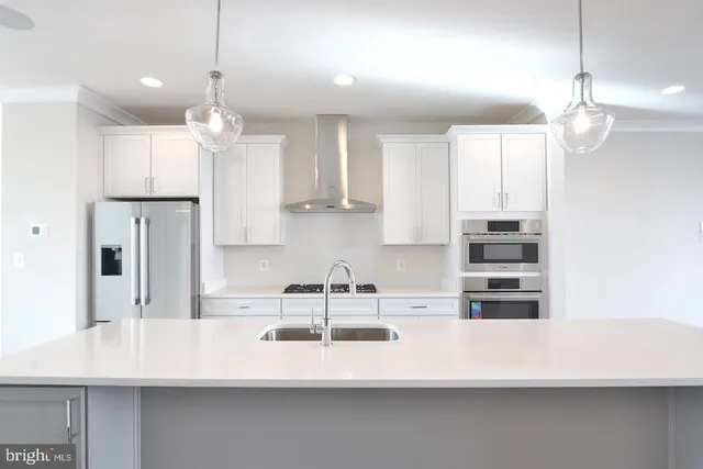a kitchen with kitchen island granite countertop a sink a center island and cabinets