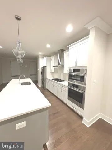 a kitchen with stainless steel appliances a sink and a refrigerator