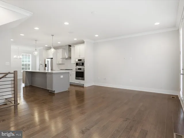 a view of kitchen with kitchen island and stainless steel appliances