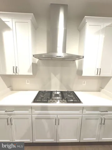 a kitchen with a refrigerator and a stove