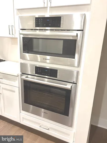 a stove top oven sitting inside of a kitchen
