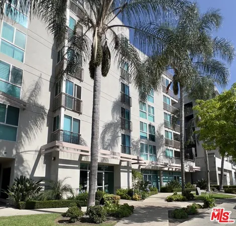 a front view of a multi story building with yard