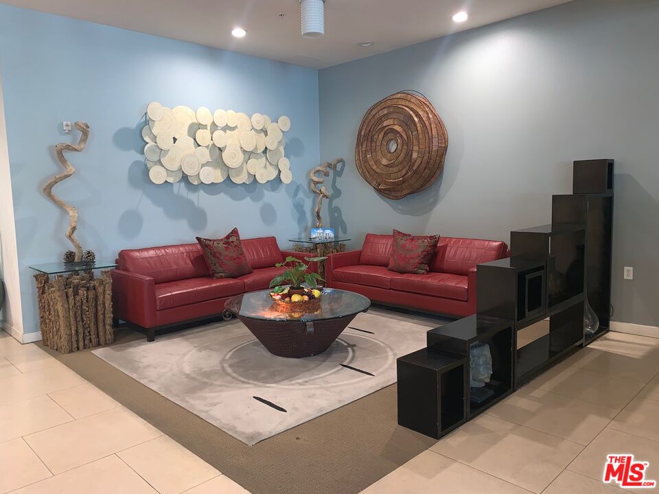 267 San Pedro Street, Unit 221 Los Angeles, CA 90012 - Photo 24 of 45 a living room with furniture a rug and a wall painting