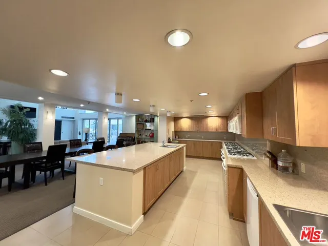 a kitchen with stainless steel appliances granite countertop a stove sink and cabinets
