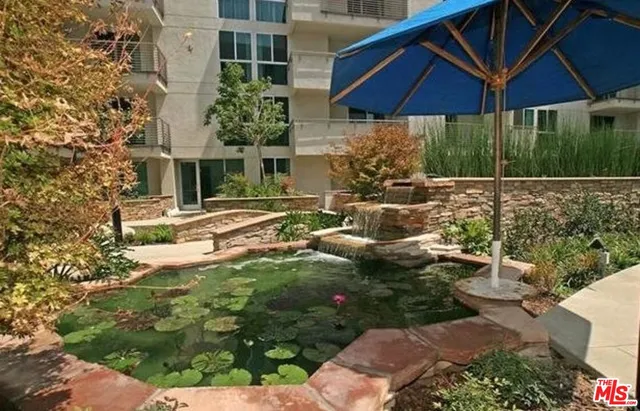 a view of a house with yard and sitting area