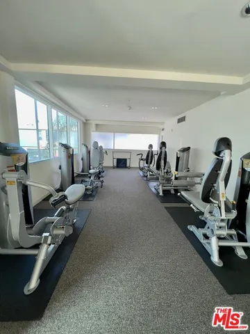 a room with gym equipment and windows