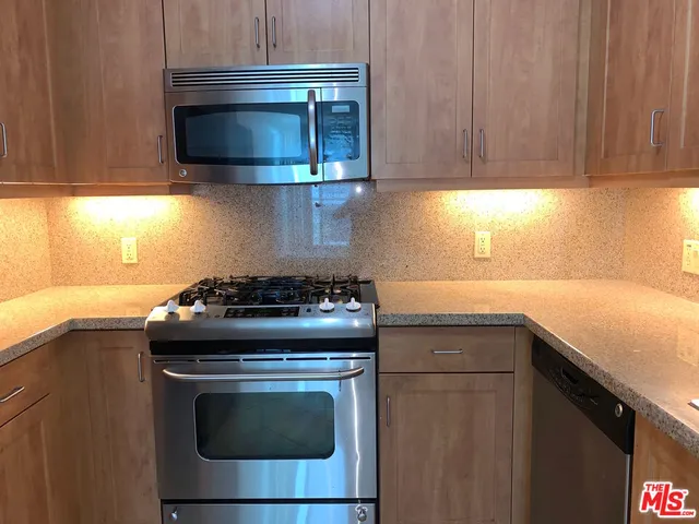 a stove top oven sitting inside of a kitchen