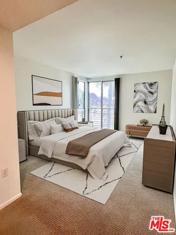 a bedroom with a bed and a couch