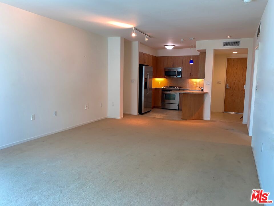 267 San Pedro Street, Unit 221 Los Angeles, CA 90012 - Photo 10 of 45 a open kitchen with a sink and a refrigerator