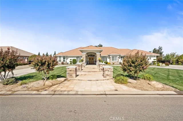 a view of multiple houses with a yard and lake view