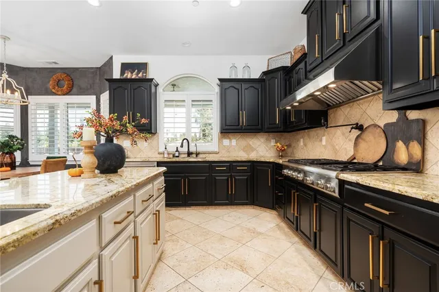 a kitchen with stainless steel appliances granite countertop a sink stove and cabinets