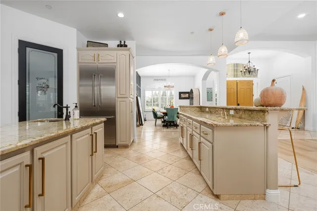 a kitchen with granite countertop a sink stove and refrigerator