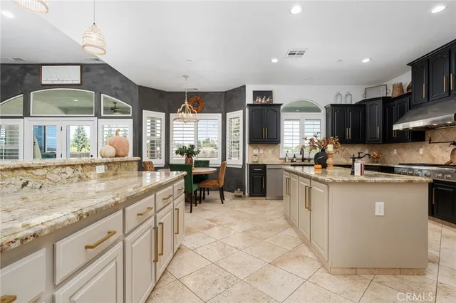 a kitchen with stainless steel appliances granite countertop a stove and a sink