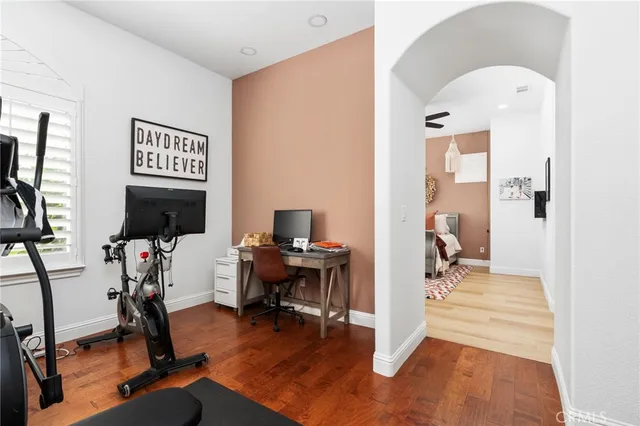 a view of a workspace with furniture and a mirror