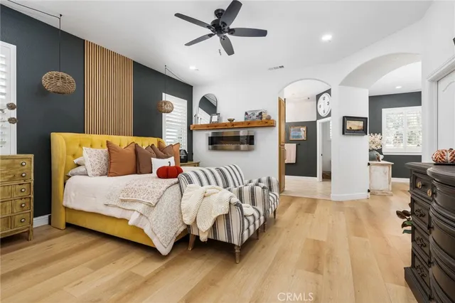 a spacious bedroom with a bed closet and flat screen tv