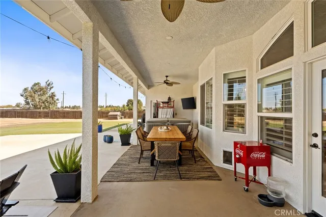 a balcony with furniture and a potted plant