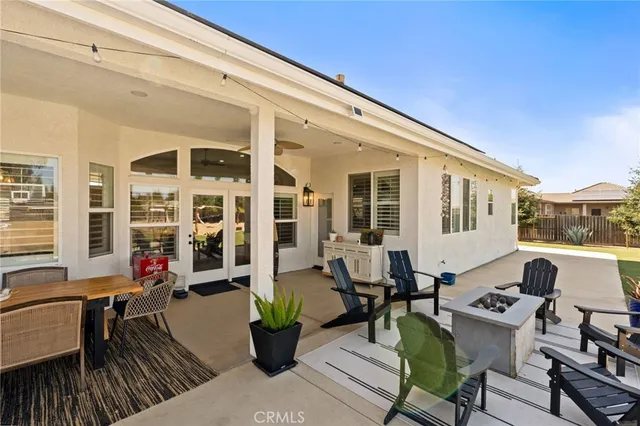 a view of a patio with couches dining table and chairs with wooden floor