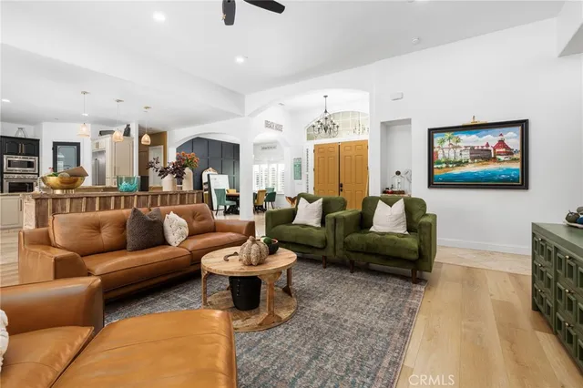 a living room with furniture a rug and a view of kitchen