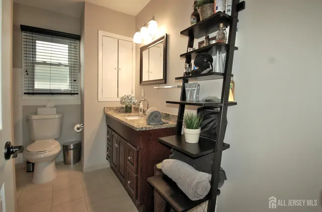 a bathroom with a sink a toilet and a window