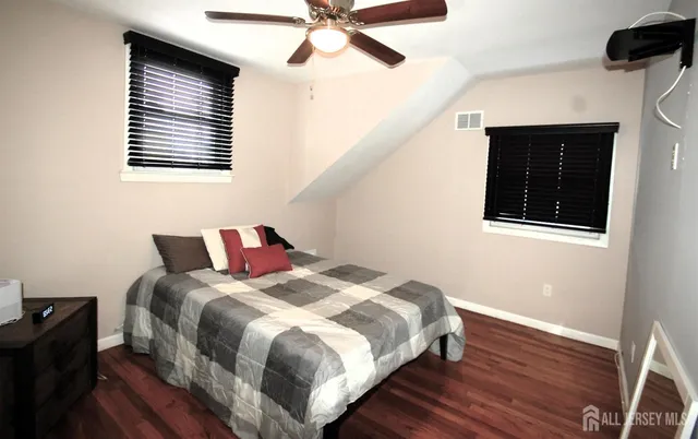 a bedroom with bed and a window