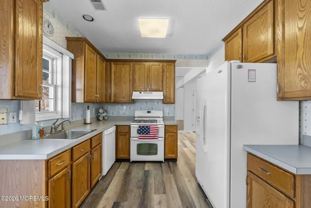 a kitchen with stainless steel appliances a refrigerator sink and cabinets