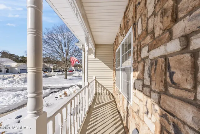 a view of a balcony with wooden floor and fence