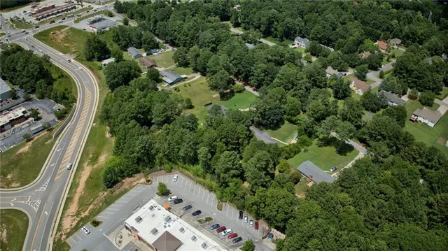 an aerial view of a residential houses with outdoor space and street view