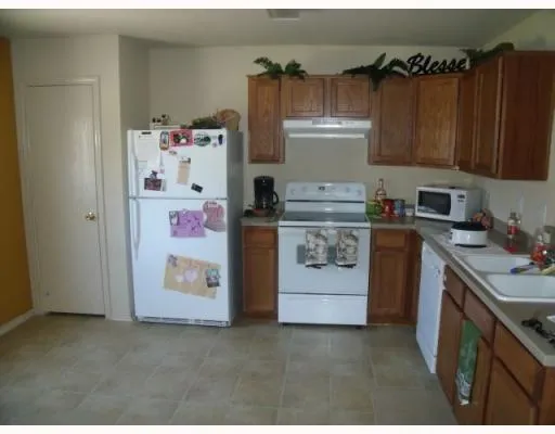 a utility room with fridge dryer and washer