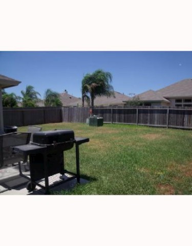 1228 Sacramento Portland, TX 78374 - Photo 4 of 4 a backyard of a house with table and chairs