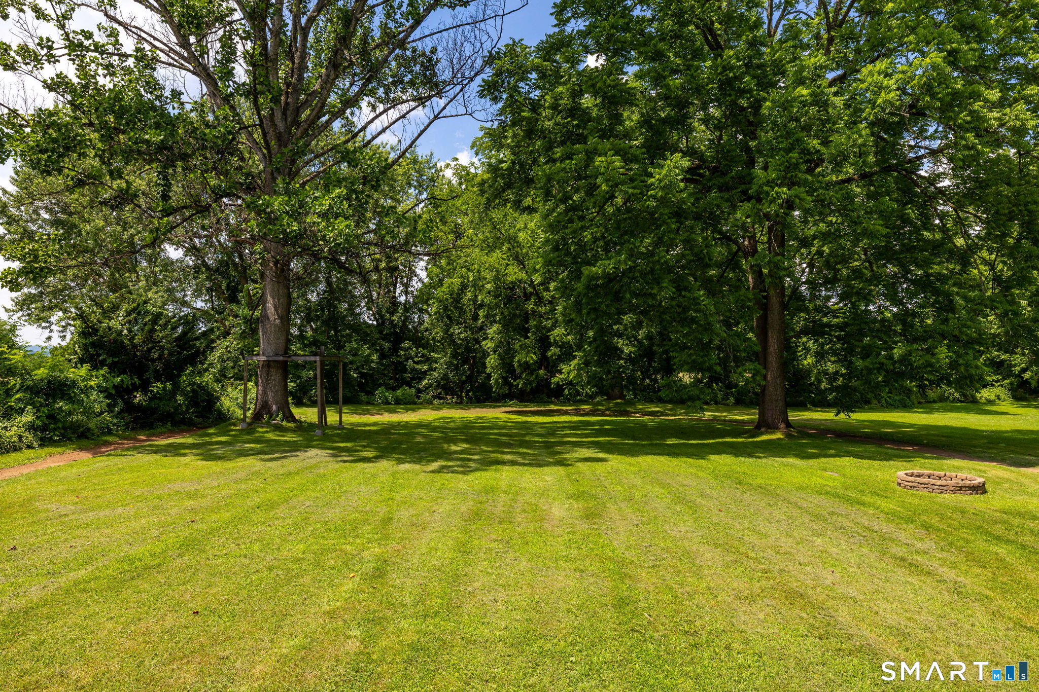 564 Main Street Portland, CT 06480 - Photo 4 of 40 Flat Level yard surrounded by mature trees, and a historic Holly Bush