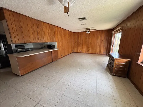 a view of kitchen with stainless steel appliances wooden cabinets