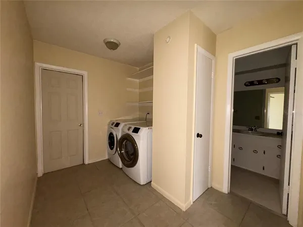 a view of a storage & utility room with closet dryer and washer