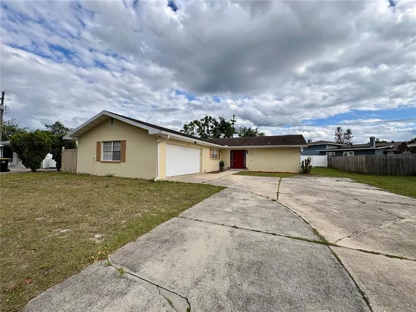 a view of a house with a yard and a garage