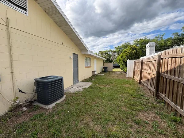 a backyard of a house with wooden floor and fence