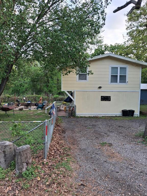 304 Ridgewood Drive Tool, TX 75143 - Photo 12 of 12 a view of a backyard with parked cars