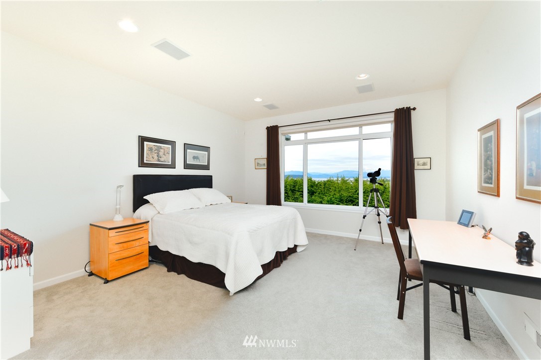 4203 Mitchell Drive Anacortes, WA 98221 - Photo 19 of 38 a bedroom with a bed and a large window