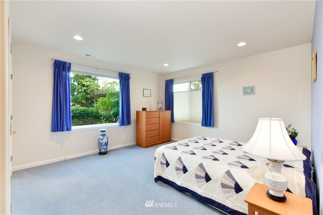 4203 Mitchell Drive Anacortes, WA 98221 - Photo 23 of 38 a bedroom with a bed and large windows