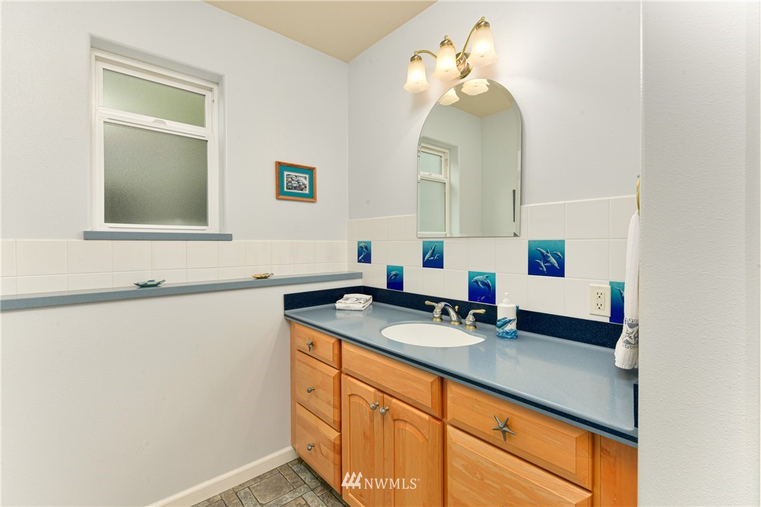 4203 Mitchell Drive Anacortes, WA 98221 - Photo 24 of 38 a bathroom with a sink and a mirror