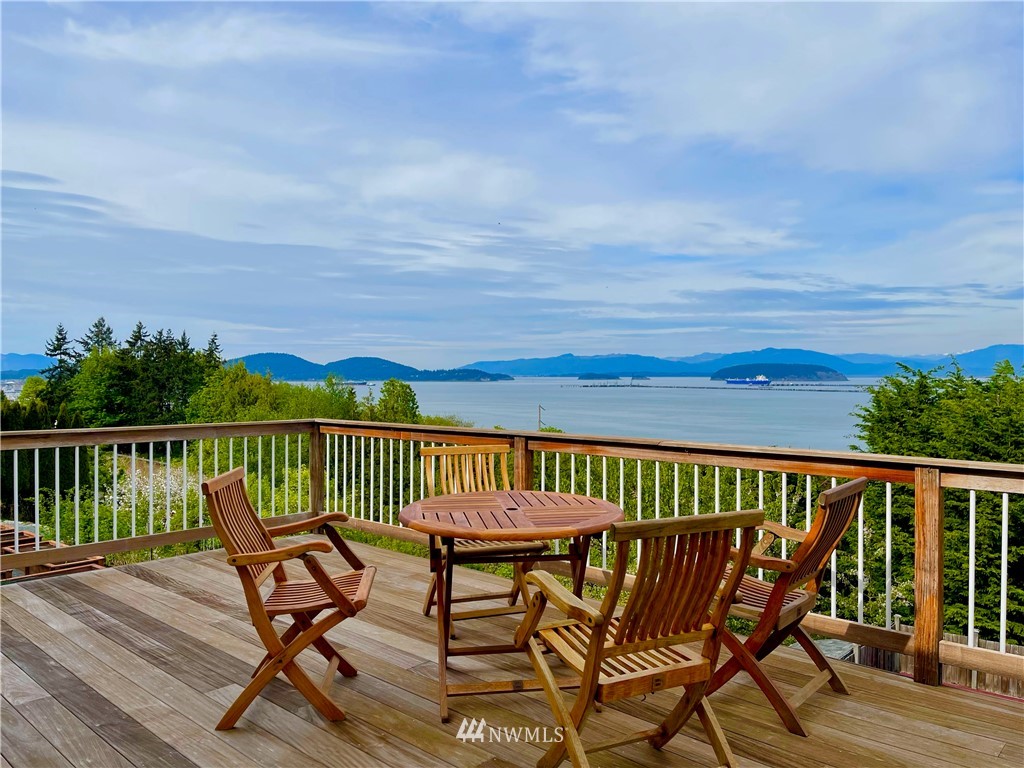 4203 Mitchell Drive Anacortes, WA 98221 - Photo 4 of 38 a view of a balcony with wooden floor chairs