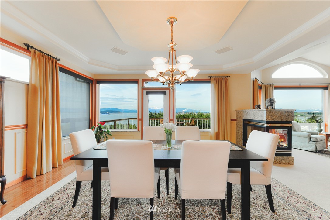4203 Mitchell Drive Anacortes, WA 98221 - Photo 9 of 38 a view of a dining room with furniture large windows and wooden floor