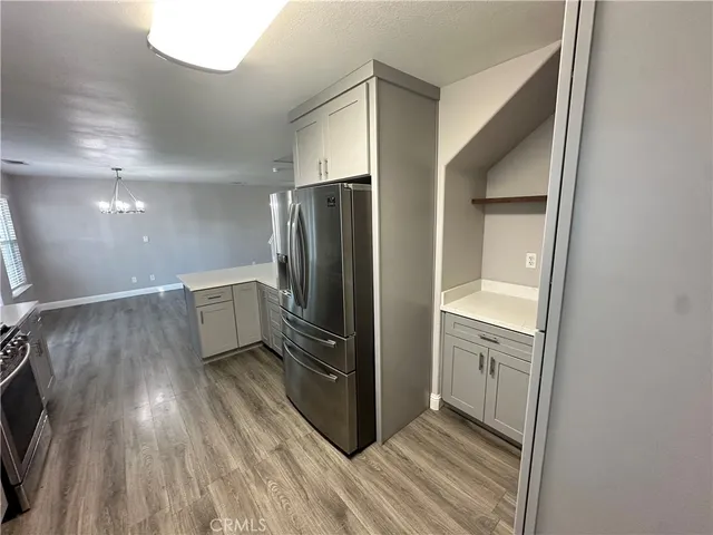 a view of a refrigerator in kitchen and wooden floor