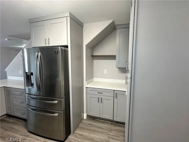a kitchen with stainless steel appliances a refrigerator and cabinets