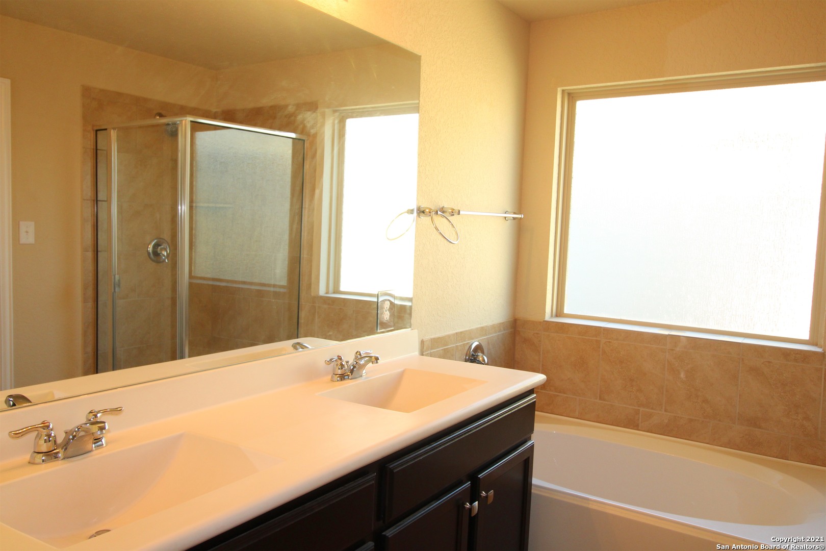9118 Hogarten Converse, TX 78109 - Photo 16 of 26 a bathroom with a granite countertop sink and a mirror