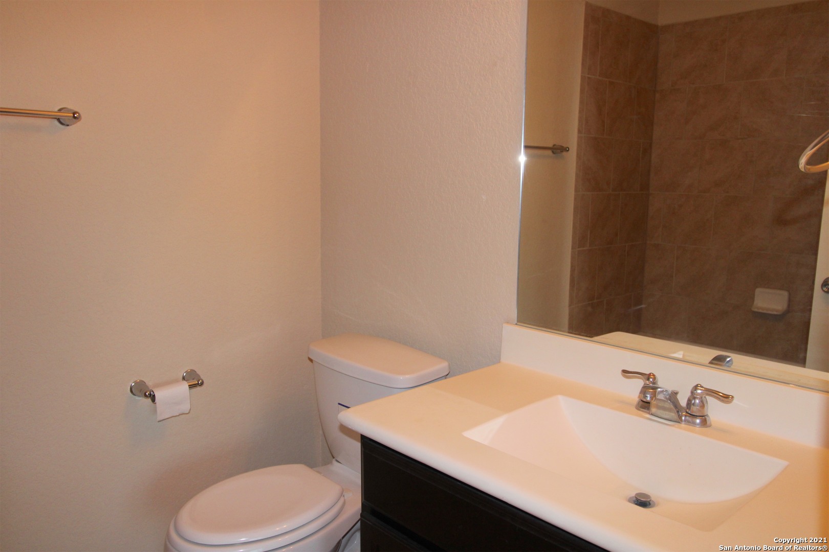 9118 Hogarten Converse, TX 78109 - Photo 21 of 26 a bathroom with a sink a toilet and mirror